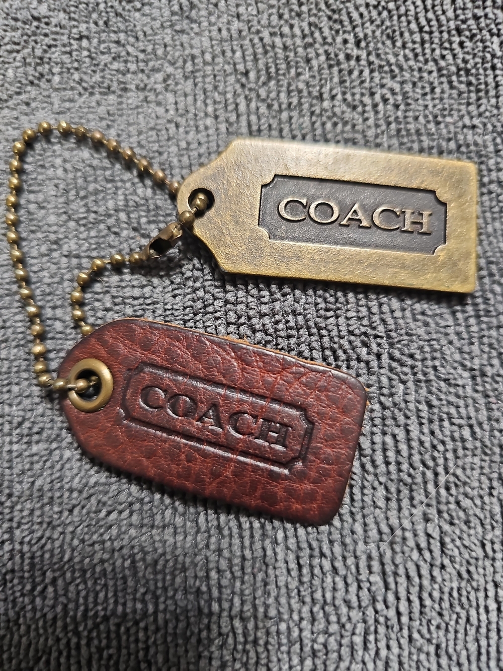 "Vintage Coach Mahogany Leatherwear" and "Raised Letter Solid Brass Plaque Fob."